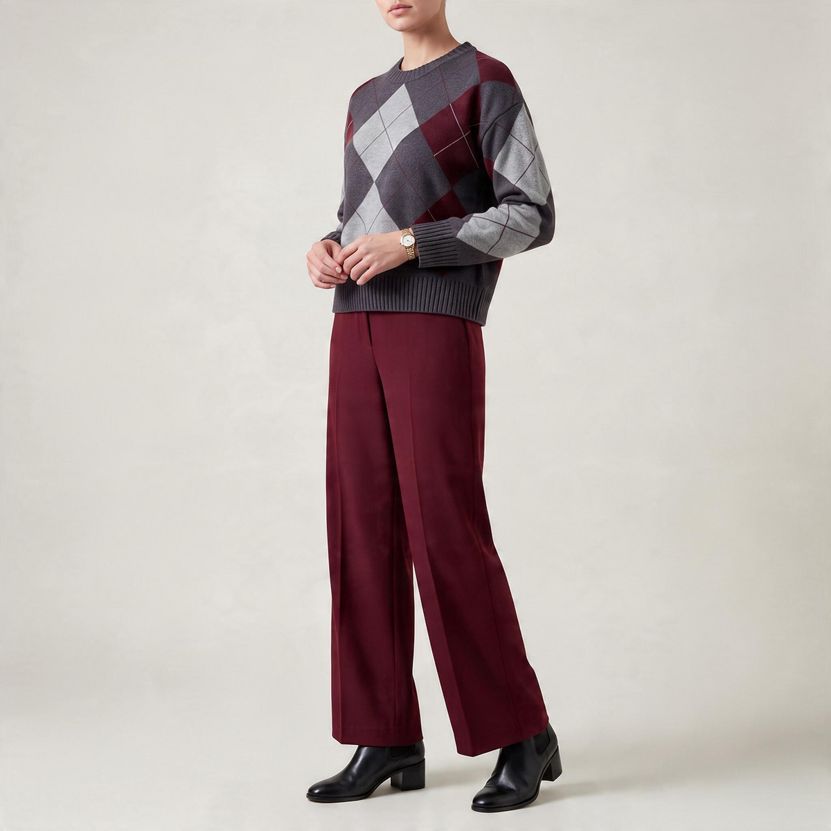 Maglione a rombi girocollo grigio e bordeaux con pantaloni ampi bordeaux e stivaletti neri